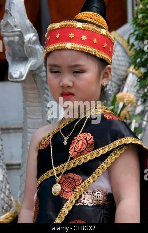 A young Asian girl is wearing a traditional costume prior to the Lao New Year Festival in Luang Prabang, Laos. Stock Photo