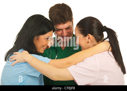 United team of three doctors standing in a hug and having funny conversation isolated on white background Stock Photo