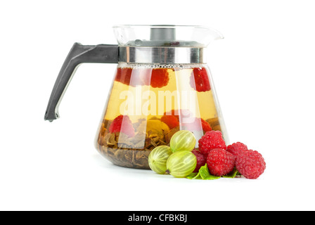 Teapot with fruit tea and berries on a white background Stock Photo