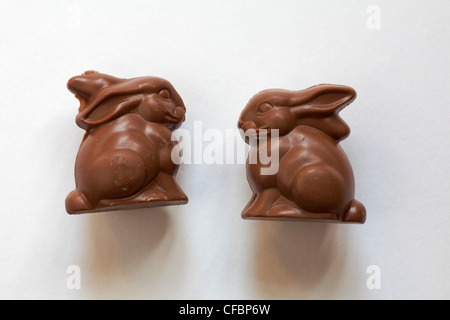 two Marks & Spencer chocolate bunnies isolated on white background - caramel chocolate double crunch bunny & Bubbly bunny ready for Easter Stock Photo