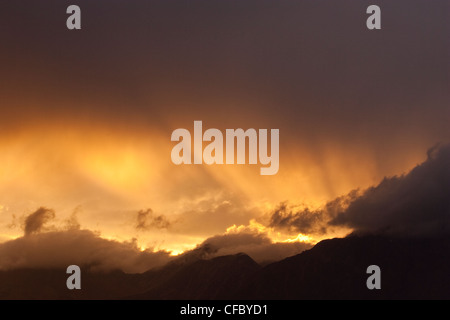 Sun rays shining through clouds over mountains, Jasper National Park, Alberta. Stock Photo