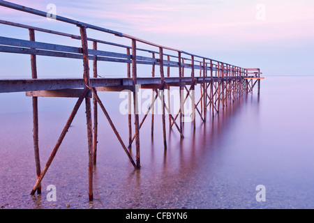 Wooden pier at dusk on Lake Winnipeg. Matlock, Manitoba, Canada. Stock Photo