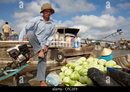 A traders steers his boat along the floating market at Cai Rang, (Can Tho) Vietnam Stock Photo