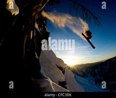 A young male skier takes huge air off a cliff in the backcountry near Whitewater Winter Resort, British Columbia, Canada