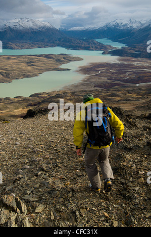 A young male hiker overlooking Perito Moreno National Park in southern Argentina, including Lago Belgrano and the Andes