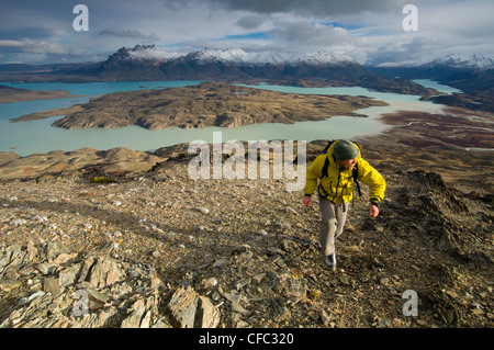 A young male hiker overlooking Perito Moreno National Park in southern Argentina, including Lago Belgrano and the Andes