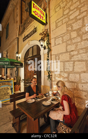 Women having dinner in restaurant Konoba Gust, Bol, Brac, Split-Dalmatia, Croatia Stock Photo
