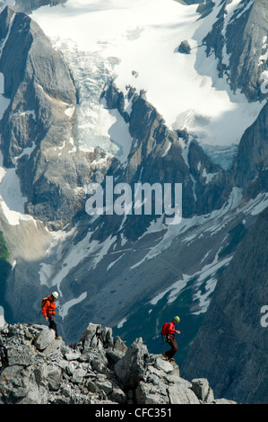 Two climbers descend the limestone slopes of Mount Templeman, Selkirk Mountains, British Columbia, Canada Stock Photo