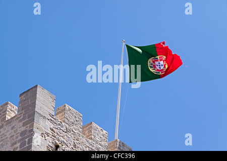 Castle in Portugal Silves on a summers day showing the Portuguese flag waving in the wind with blue sky Stock Photo