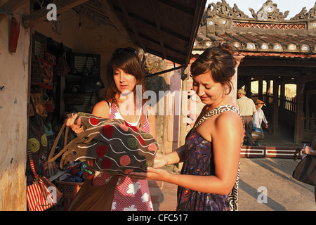 Two women shopping, Chua Cau, Japanese Bridge, Hoi An, Annam, Vietnam Stock Photo