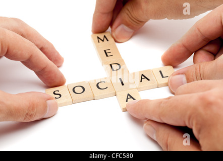 Hands forming the term 'social media' from letters Stock Photo