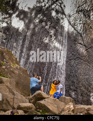 EL YUNQUE NATIONAL FOREST, PUERTO RICO - Visitors pose for photo at La Coca Falls. Stock Photo