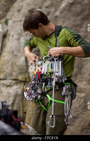 A young man prepares to climb the Abyss 5.10b, Rattle Snake Point, ON Stock Photo