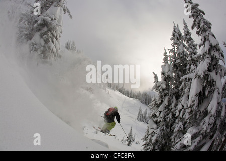 A male freeskier airing a cliff in the Revelstoke Resort Backcountry, BC Stock Photo