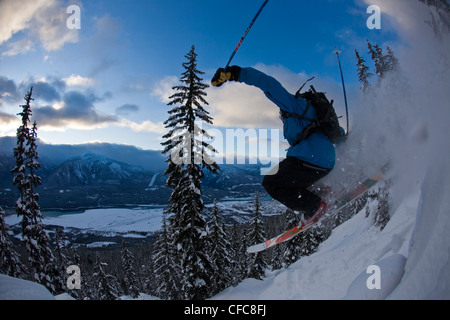 A male freeskier airing a cliff in the Revelstoke Resort Backcountry, BC Stock Photo