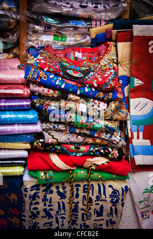 A selection of fabric stacked up and for sale in a souk in Cairo, Egypt Stock Photo