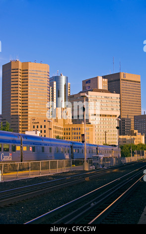 Via rail train at station, downtown Winnipeg skyline, Manitoba, Canada Stock Photo