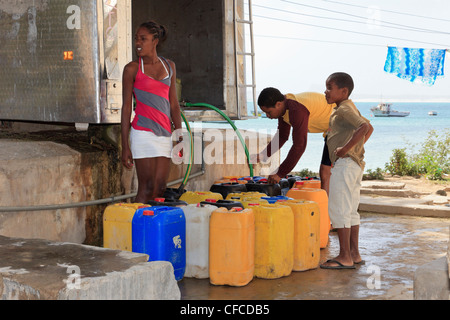 Sal Rei, Boa Vista, Cape Verde Islands. Local people with containers for collecting desalinated drinking water from a bowser Stock Photo