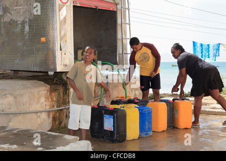 Local people with containers for collecting desalinated fresh drinking water from a bowser. Sal Rei Boa Vista Cape Verde Islands. Stock Photo