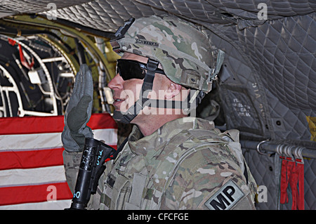 LOGAR PROVINCE, Afghanistan – Sgt. 1st Class Jeremy K. Schwanke, a native of Newport News, Va., raises his right hand during his reenlistment ceremony onboard a CH-47 Chinook helicopter assigned to 2nd Aviation Brigade, 82nd Combat Aviation Brigade. Schwanke is a military police operations sergeant assigned to provost marshal office with the 3rd Brigade Combat Team, 1st Armored Division deployed from Fort Bliss, Texas to Forward Operating Base Shank. This is Schwanke’s fourth and final indefinite reenlistment. Stock Photo