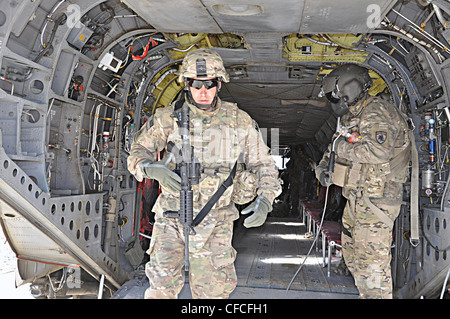 LOGAR PROVINCE, Afghanistan – Sgt. 1st Class Jeremy K. Schwanke, a native of Newport News, Va., walks down the helicopter ramp after his reenlistment ceremony onboard a CH-47 Chinook helicopter assigned to 2nd Aviation Brigade, 82nd Combat Aviation Brigade. Schwanke is a military police operations sergeant assigned to provost marshal office with the 3rd Brigade Combat Team, 1st Armored Division deployed from Fort Bliss, Texas to Forward Operating Base Shank. This is Schwanke’s fourth and final indefinite reenlistment. Stock Photo