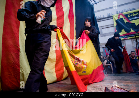 Catalan separatists burn a Spanish flag during the celebrations of National Day of Catalonia in Barcelona, independence day. Stock Photo