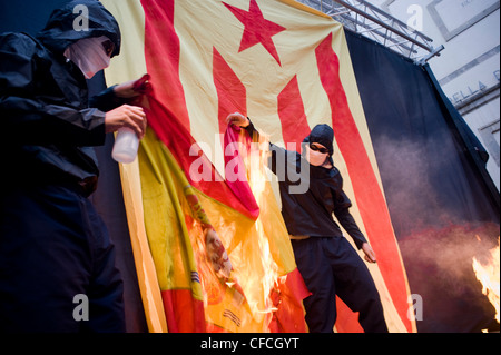 Catalan separatists burn a Spanish flag during the celebrations of National Day of Catalonia in Barcelona, independence day. Stock Photo