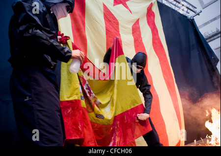 Catalan separatists burn a Spanish flag during the celebrations of National Day of Catalonia in Barcelona, independence day. Stock Photo