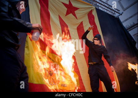 Catalan separatists burn a Spanish flag during the celebrations of National Day of Catalonia in Barcelona, independence day. Stock Photo