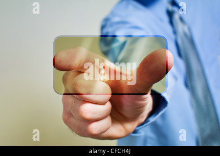 Businessman in dark suit is pressing a touchscreen button Stock Photo