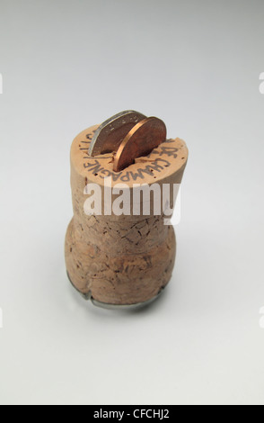 A Champagne cork with a 20p piece and 1p piece to symbolise turning 21 years old (in England). Stock Photo
