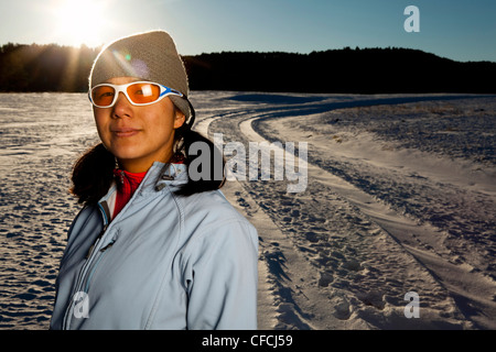 a Japanese-American woman has her portrait taken after running down a snowy road in Custer State, South Dakota. Stock Photo
