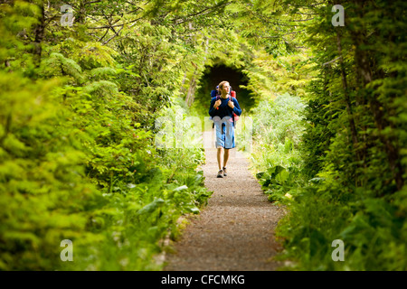 teenage hiker walks along pathway San Josef Bay Stock Photo