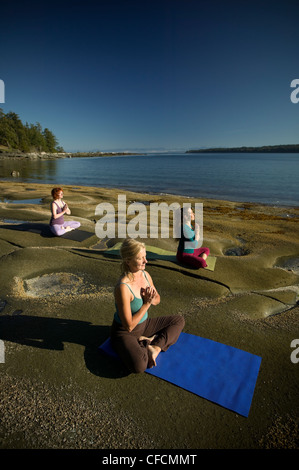 Yogpractioners relax meditate early morning sun Stock Photo