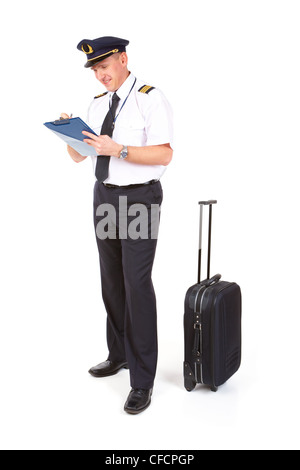 Cheerful pilot wearing uniform with epaulets standing with trolley bag Stock Photo