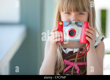 Girl holding toy camera Stock Photo