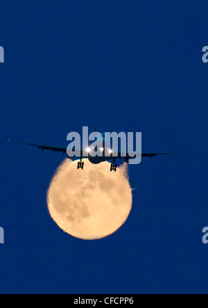 Airbus 330 passing full moon approach Vancouver Stock Photo