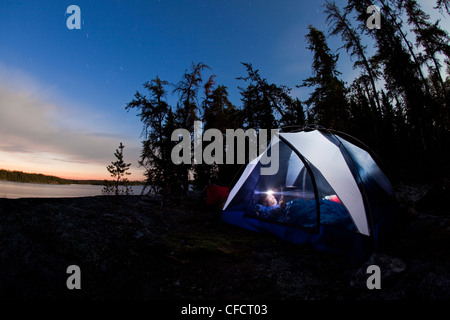 A young man camping for 2 weeks in Wabakimi Provincial Park, Northern Ontario, Canada Stock Photo