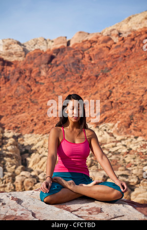A fit young asian woman practicing yoga while on a rock climbing trip, Red Rocks, Las Vegas, Nevada, United States of America