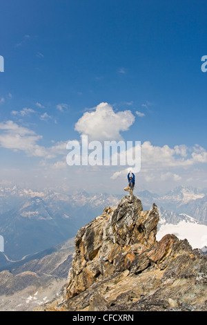 Young man mountain climbing the classic north west ridge of Mt. Sir Donald, Glacier National Park, British Columbia, Canada Stock Photo
