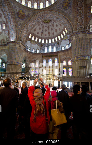 Tourists in the main Dome, Sultan Ahmed Mosque (Blue Mosque), Istanbul, Turkey Stock Photo