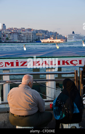 Floating restaurants on the Golden Horn by the Galata Bridge, located in the Eminönü district of Istanbul, Turkey. Stock Photo