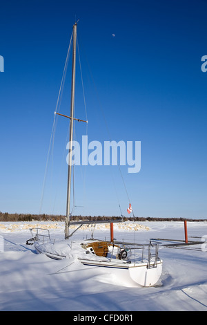 Sailboat frozen in Lake Winnipeg. Victoria Beach Harbour, Manitoba, Canada. Stock Photo