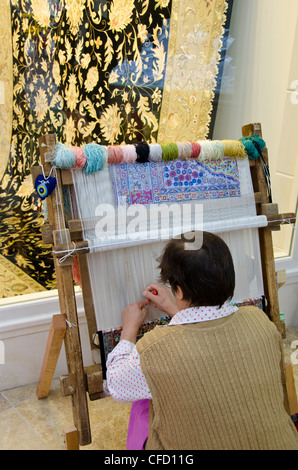 Rug weaving in Kuşadası, a resort town on Turkey's Aegean coast in Aydın Province Stock Photo