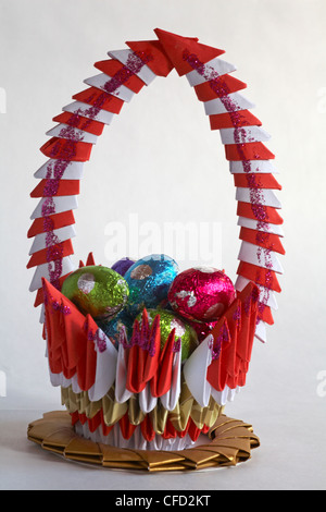 red and white origami baskets with mini Easter eggs isolated on white background Stock Photo