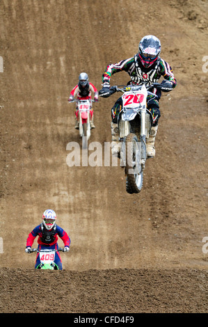 Motocross rider #20 gets airborne during jump Stock Photo