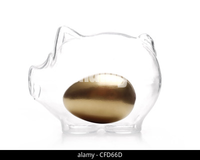 Golden egg inside glass piggy-bank over white background Stock Photo