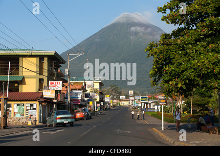 A view of Volcano Arenal from downtown La Fortuna Costa Rica. early and the streets are quiet before all the tourists arrive. Stock Photo