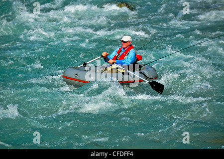 Man in raft, fly fishing, Copper River, British Columbia, Canada Stock Photo