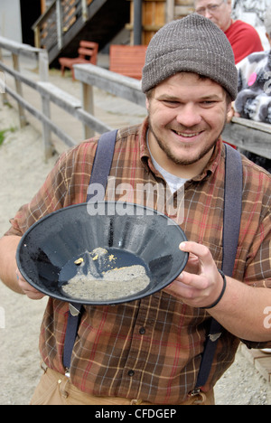 Miner demonstrating the art of gold panning at the Klondike Gold Fields in Skagway, Alaska Stock Photo